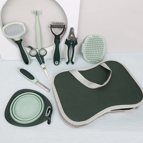 Collection of pet grooming tools and accessories on a white surface